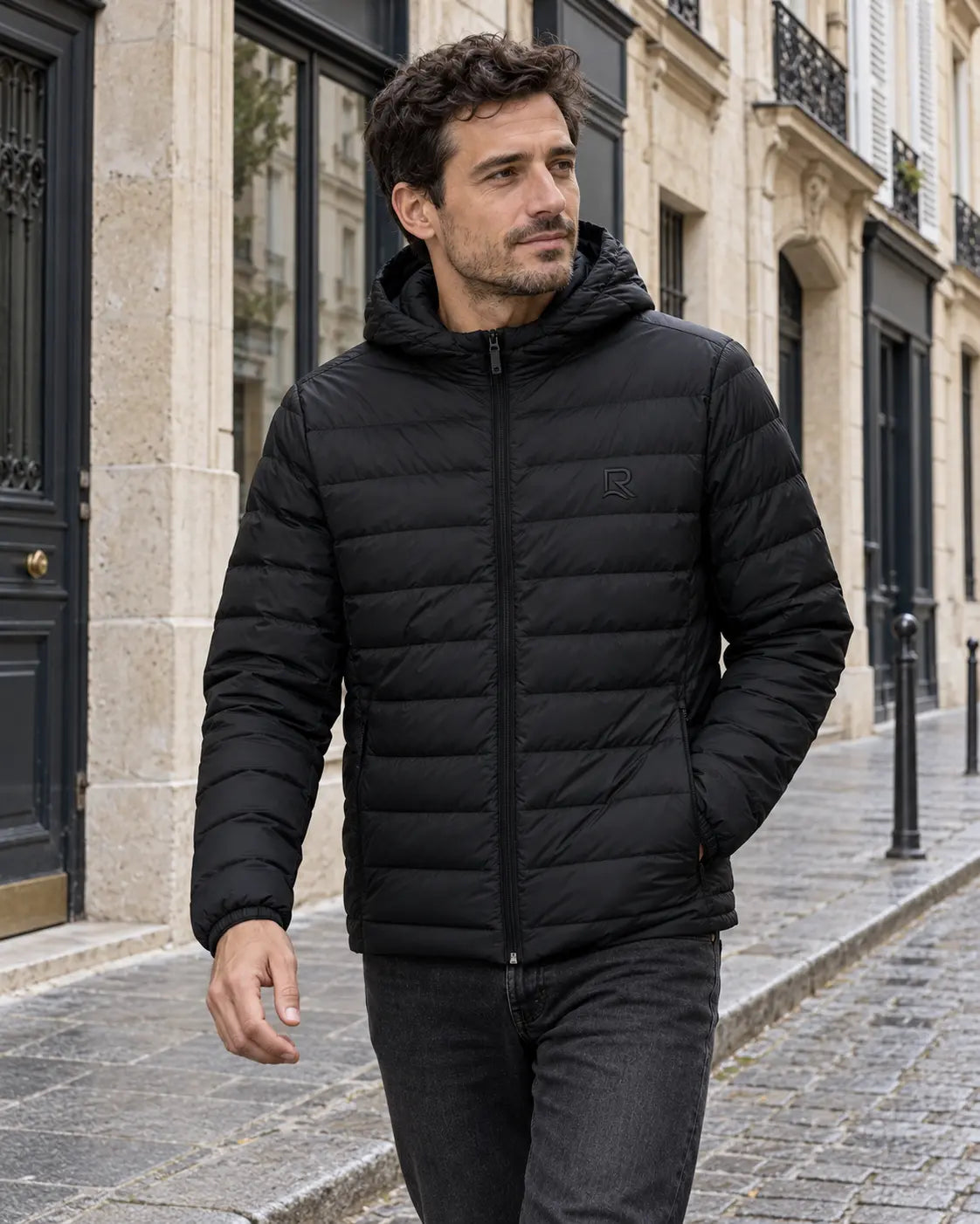 Veste matelassée homme L’Horizon RIVHEX noire portée en ville, broderie ton sur ton sur la poitrine